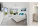 Bright main bedroom features a ceiling fan, many windows overlooking the backyard, and ensuite bathroom at 4228 Isonzo Way, Wesley Chapel, FL 33543