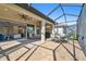 Screened patio with brick pavers, ceiling fans and easy access to the kitchen and living area, ideal for outdoor entertaining at 4228 Isonzo Way, Wesley Chapel, FL 33543