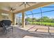 The covered, screened patio provides an inviting space to relax and enjoy the beautiful views of the landscaped yard at 4228 Isonzo Way, Wesley Chapel, FL 33543