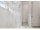 The bright bathroom has a glass-enclosed shower with white tiling and a built-in bench at 4228 Isonzo Way, Wesley Chapel, FL 33543