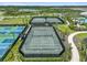 Aerial view of the community tennis courts surrounded by lush greenery at 4228 Isonzo Way, Wesley Chapel, FL 33543