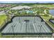 Overview of the community tennis courts, showcasing well-maintained courts, lights, and surrounding landscape at 4228 Isonzo Way, Wesley Chapel, FL 33543