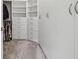 Bright walk-in closet featuring custom storage solutions, including adjustable shelves and drawers at 4228 Isonzo Way, Wesley Chapel, FL 33543