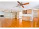 Open living room with decorative wallpaper, fireplace, built-in bookcases, and polished wood floor at 4315 W Cleveland St, Tampa, FL 33609