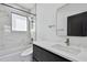 Modern bathroom with sleek vanity, beautiful mirror, tub, shower, and marble-style tile surround at 4501 24Th S Ave, St Petersburg, FL 33711