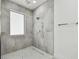 A bathroom features a walk-in shower with gray tiling and modern fixtures at 4501 24Th S Ave, St Petersburg, FL 33711