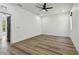 A large bedroom with light wood flooring is brightened by a door leading to a lush green view at 4501 24Th S Ave, St Petersburg, FL 33711