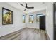 Light-filled bedroom with three windows, showcasing wood floors and a ceiling fan for a cozy atmosphere at 4501 24Th S Ave, St Petersburg, FL 33711