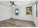 Bright bedroom featuring wood floors, a modern ceiling fan, and ample natural light at 4501 24Th S Ave, St Petersburg, FL 33711