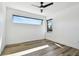Minimalist bedroom with wood floors, sleek ceiling fan, and a window for natural light and creates a serene retreat at 4501 24Th S Ave, St Petersburg, FL 33711