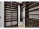 A large walk-in closet features dark wood shelving and drawers, creating ample storage at 4501 24Th S Ave, St Petersburg, FL 33711