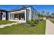 Charming modern home with a covered porch featuring stylish outdoor seating and a beautifully landscaped front yard at 4501 24Th S Ave, St Petersburg, FL 33711