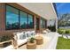 A cozy front porch with modern seating arrangement, wood siding, and dark-trimmed windows at 4501 24Th S Ave, St Petersburg, FL 33711