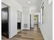 Hallway with wood flooring leading to various rooms, offering a glimpse of the home's layout and natural light at 4501 24Th S Ave, St Petersburg, FL 33711