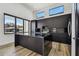A modern kitchen features an island, sleek black cabinets, and two large windows at 4501 24Th S Ave, St Petersburg, FL 33711