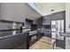 Modern kitchen featuring sleek black cabinetry, stainless steel appliances, and black marble countertops at 4501 24Th S Ave, St Petersburg, FL 33711