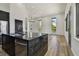 Open-concept kitchen boasts a large black marble island, stainless steel appliances, and modern lighting at 4501 24Th S Ave, St Petersburg, FL 33711