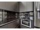 A modern kitchen features black marble countertops, sleek cabinets, and stainless steel microwave at 4501 24Th S Ave, St Petersburg, FL 33711