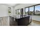 Modern kitchen boasts a black marble island, stainless steel appliances, and sleek black window frames at 4501 24Th S Ave, St Petersburg, FL 33711