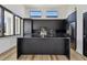 Chic kitchen with an island and custom black cabinets, stainless steel appliances, and granite countertops at 4501 24Th S Ave, St Petersburg, FL 33711