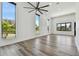 Living room with tall windows, wood floors, and contemporary ceiling fan at 4501 24Th S Ave, St Petersburg, FL 33711