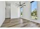 Bright living room featuring tall windows, wood flooring, and modern ceiling fan at 4501 24Th S Ave, St Petersburg, FL 33711