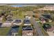 Aerial view of a home in a suburban neighborhood, surrounded by green spaces and other residential properties on a sunny day at 5433 Chestnut Ridge Rd, Dade City, FL 33523