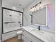 Well-lit bathroom featuring a tub/shower combination and a vanity with illuminated mirror at 5433 Chestnut Ridge Rd, Dade City, FL 33523