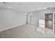 Bright bedroom with a window and neutral carpeting leads to another room at 5433 Chestnut Ridge Rd, Dade City, FL 33523