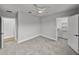 Neutral bedroom with ceiling fan, carpet, and access to the closet at 5433 Chestnut Ridge Rd, Dade City, FL 33523