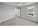 Bedroom featuring a ceiling fan, closet, and a large window at 5433 Chestnut Ridge Rd, Dade City, FL 33523