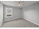 Bright bedroom with a window offering natural light and neutral gray carpet at 5433 Chestnut Ridge Rd, Dade City, FL 33523