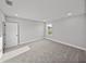 Sun-filled bedroom features neutral walls, plush carpeting, and a bright window at 5433 Chestnut Ridge Rd, Dade City, FL 33523