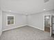 Bright bedroom with a window and neutral carpeting leads to the Primary bathroom at 5433 Chestnut Ridge Rd, Dade City, FL 33523