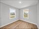 Cozy bedroom features natural light from two windows overlooking the front yard at 5433 Chestnut Ridge Rd, Dade City, FL 33523