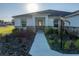 Inviting entrance with a stylish front door, stone accents, and professionally landscaped surroundings at 5433 Chestnut Ridge Rd, Dade City, FL 33523