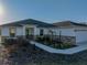 Charming single-story home with stone accents and meticulously landscaped front yard and concrete walkway at 5433 Chestnut Ridge Rd, Dade City, FL 33523