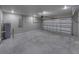 Spacious garage with concrete floor and white insulated garage door at 5433 Chestnut Ridge Rd, Dade City, FL 33523
