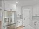 Modern kitchen featuring stainless steel refrigerator, white cabinets, and tile backsplash at 5433 Chestnut Ridge Rd, Dade City, FL 33523