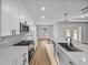Modern kitchen with white cabinets, quartz countertops, stainless steel appliances, and sleek hardware at 5433 Chestnut Ridge Rd, Dade City, FL 33523