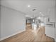 Open floor plan with living room and kitchen featuring light wood flooring at 5433 Chestnut Ridge Rd, Dade City, FL 33523