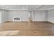 Open living area with an electric fireplace and wood-look flooring at 5433 Chestnut Ridge Rd, Dade City, FL 33523