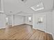 Spacious living room featuring a decorative front door, recessed lighting, and wood-look floors at 5433 Chestnut Ridge Rd, Dade City, FL 33523