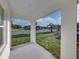 Covered patio with a view of the landscaped front yard and neighborhood at 5433 Chestnut Ridge Rd, Dade City, FL 33523