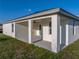 Covered patio featuring sturdy columns, a ceiling fan, and access to the backyard at 5433 Chestnut Ridge Rd, Dade City, FL 33523