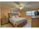 Cozy bedroom with a king-size bed, coastal-themed decor, and a ceiling fan for added comfort at 6310 Midnight Pass Rd # 204N, Sarasota, FL 34242
