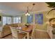 Charming dining area with beach-themed art, stylish table setting, and open living space at 6310 Midnight Pass Rd # 204N, Sarasota, FL 34242