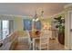 Cozy dining area with beach-themed art, stylish table setting, and beautiful lighting at 6310 Midnight Pass Rd # 204N, Sarasota, FL 34242