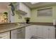 Functional kitchen features stainless steel appliances, granite countertops, and ample cabinet space for storage at 6310 Midnight Pass Rd # 204N, Sarasota, FL 34242