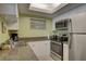 Well-lit kitchen featuring stainless steel appliances, granite countertops, and plenty of cabinet storage at 6310 Midnight Pass Rd # 204N, Sarasota, FL 34242